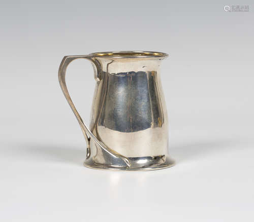 An early 20th century Arts and Crafts silver tankard, after a design by Oliver Baker for Liberty &