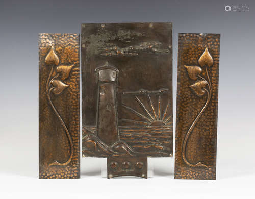 An early 20th century Arts and Crafts embossed copper panel, decorated with a lighthouse and setting