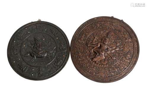Tibet, 19th centuryTwo embossed copper medallions depicting deities, one with hard stone inlays Diam: 42 cm and 45 cm(one handle missing)