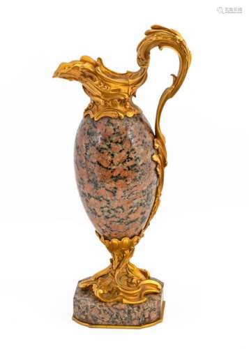 Decorative ewer in the Louis XV style in pink granite and chased and gilded bronze French work, Napoleon III period, 19thH: 38,5 cm(accidents)Provenance: Château de la Roquette (Hainaut) A document signed by François d'Ansembourg on October 20, 1990is attached.