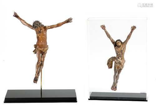 Two carved wooden Christ on the crossTraces of polychromy and gildingOne probably Portuguese 17thcentury Presented in plexiglass display casesH: 30 and 32.5 cm(accidents and restorations)