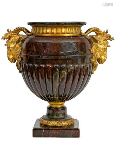 Large Louis XVI style vase with two handles in the shape of a ram's head in green and red serpentine carved with gadroons and chased and gilded bronze Frenchwork, 19thcentury H period: 51 cm(missing lid and restorations)Provenance: Château de la Roquette (Hainaut) A certificate of expertise signed by François d'Ansembourg on March 27th 2001is attached.