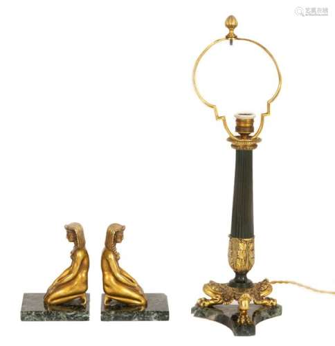 Pair of gilt bronze and green marble bookends in Empire style decorated with a kneeling naked Egyptian woman A Restoration style tripod lamp base in bronze with green patina, gilt bronze and greenmarble is attached Early 20thcentury period H: 17.5 and 59 cm(accidents)
