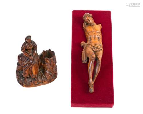 Christ on the crossCarved boxwood Flemishwork, 17th century H: 19 cm (missing arms and accidents) A 19th century boxwood matchbox holder also in the shape of a fisherman's wife sitting next to a trunk H: 12 cm (accidents) is attached.