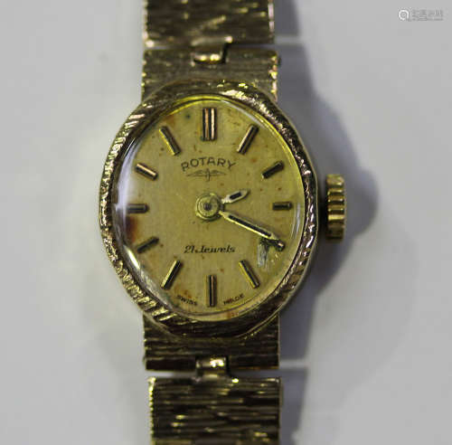 A Rotary 9ct gold lady's bracelet wristwatch, the signed oval gilt dial with baton hour markers,