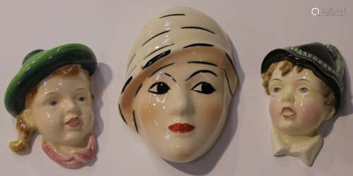 A Crown Devon Art Deco wall mask, 1930s, painted by Dorothy Ann, modelled as a lady wearing a hat,