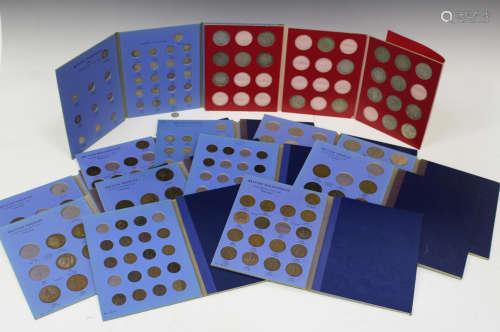 A collection of Whitman coin folders, each containing half-crowns, florins, sixpences, pennies and