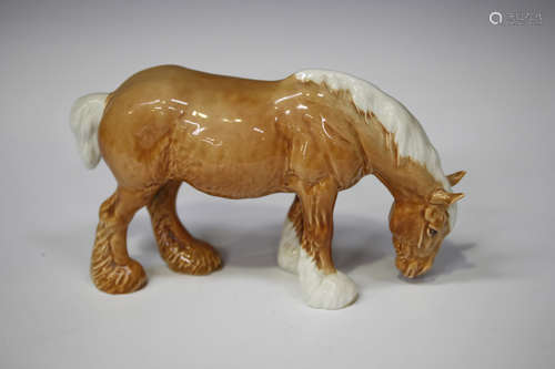 A Beswick palomino grazing shire, No. 1050, height 13.5cm.Buyer’s Premium 29.4% (including VAT @