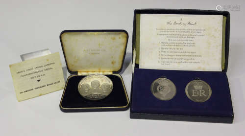 A silver proof medallion commemorating Man's First Moon Landing 1969, with case, and a pair of