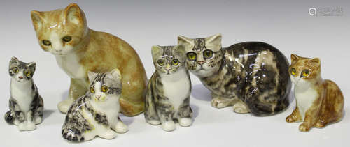 Five Winstanley cats, each with inset glass eyes, height of tallest 20cm, and a Hinton pottery cat.