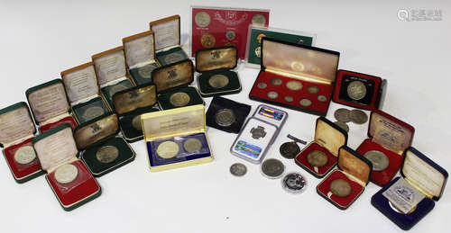 A collection of world commemorative coins and medallions, together with a British War Medal to 'J