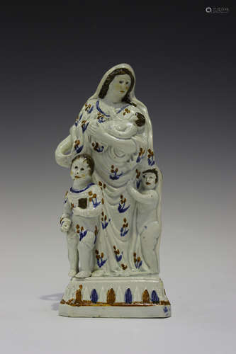 A Prattware pearlware figure representing Charity, circa 1790, decorated in ochre, brown and blue,