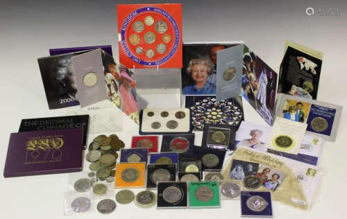 A collection of British commemorative coinage, including Royal Mint year sets, and a small group
