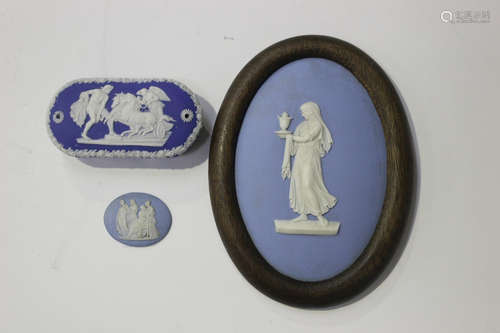 A Wedgwood pale blue jasperware oval plaque, 19th century, sprigged in white with a muse holding