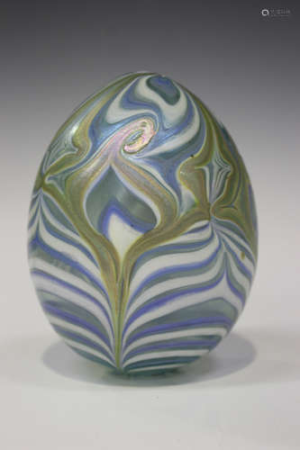 A Vandermark Merritt iridescent glass egg paperweight, circa 1978, with stylized peacock feather and