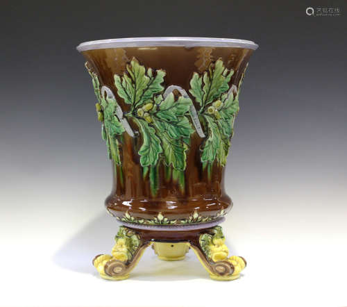 A large majolica jardinière and stand, late 19th century, probably English, the brown glazed