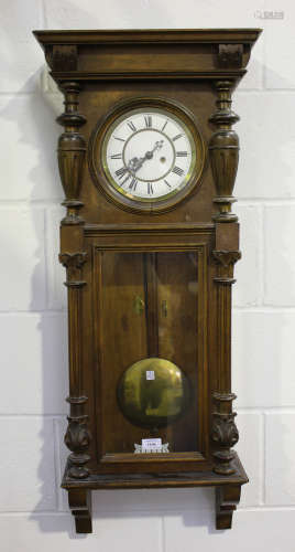 A late 19th century walnut Vienna wall clock by Gustav Becker, the eight day movement striking on