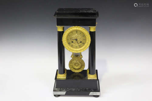 A late 19th century ormolu mounted ebonized portico mantel clock with eight day movement striking on