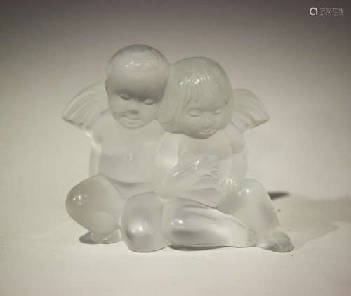 A Lalique frosted glass figure group of two seated cherubs, post-1945, etched 'Lalique ® France'