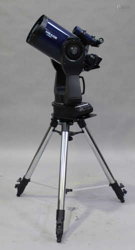 A Meade LX200 GPS celestial telescope, together with accessories, lenses and a heavy tripod stand.