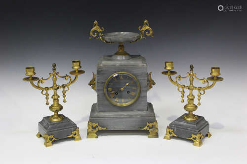 A late 19th century French gilt brass and grey marble mantel clock garniture, the clock with eight