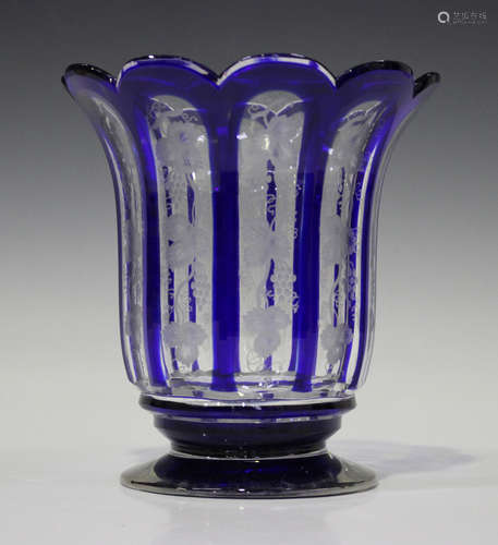 A Bohemian blue flashed glass vase, late 19th century, the faceted, flared cylindrical body engraved