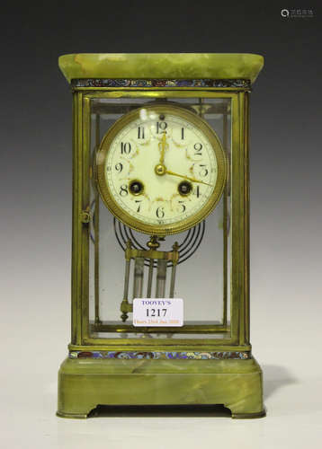 An early 20th century French brass, onyx and champlevé enamel four glass mantel clock with eight day