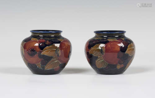 A small pair of Moorcroft Pomegranate pattern vases, circa 1928-25, impressed marks to bases, height