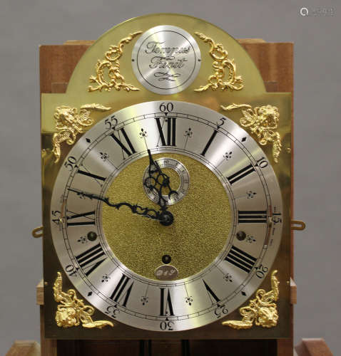 A 20th century oak longcase clock with eight day three train movement chiming on gongs, the brass