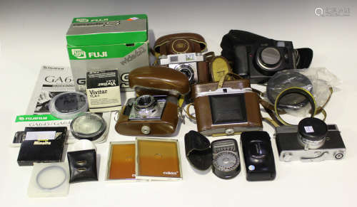 A collection of cameras and accessories, including a Fuji GS645 S Professional camera, boxed, a Fuji