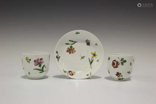 Two Continental porcelain teacups and a matching saucer, probably Doccia, late 18th century, painted