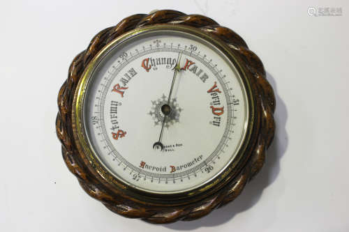 A late Victorian aneroid barometer, the printed ceramic dial inscribed 'B Cooke & Son Hull' within a