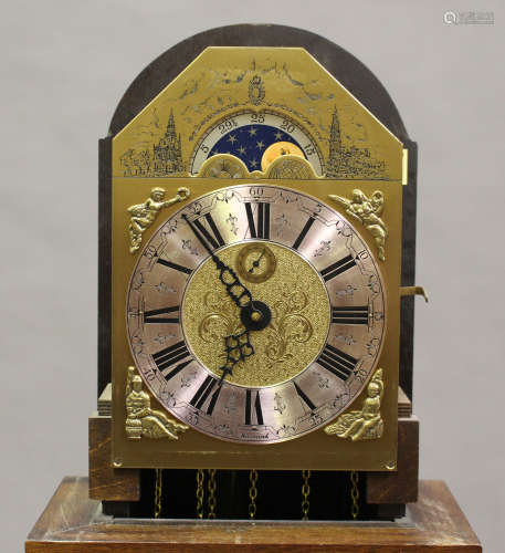 A 20th century Dutch walnut longcase clock with three train movement striking on gongs, the brass
