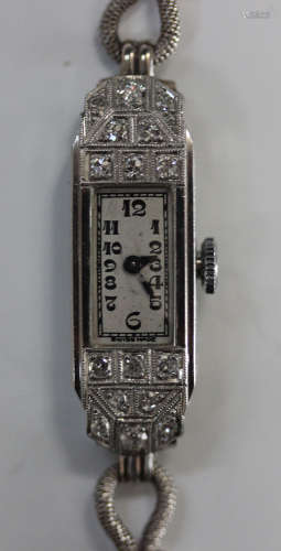 A platinum and diamond lady's dress wristwatch with jewelled Swiss lever movement, the silvered dial
