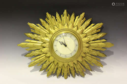 A 20th century giltwood sunburst wall clock with quartz movement, the circular dial with Arabic