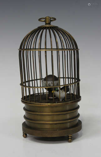 A 20th century brass novelty singing bird automaton clock, within a wirework case on turned feet,