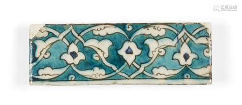 A Damascus Iznik tile, 16th century, of rectangular form, the turquoise ground decorated in white,