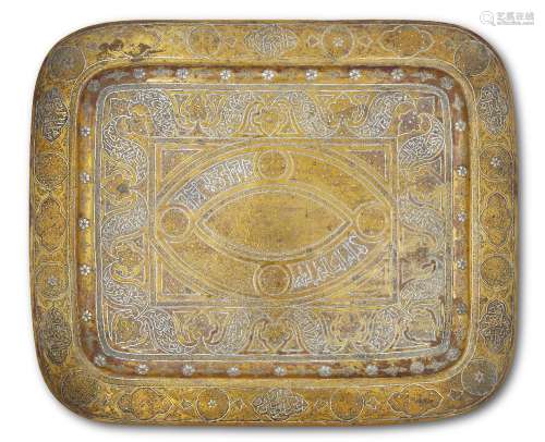 A silver inlaid brass rectangular tray, Syria or Egypt, 19th century, the central well with an ovoid