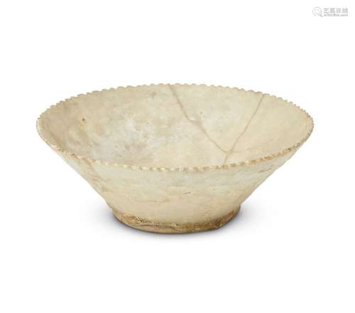 A restored Gurgan-ware bowl with pierced decoration and crenellated rim, Eastern Iran, late 12th-