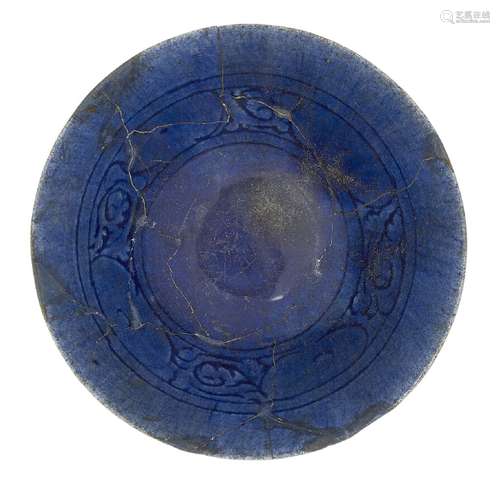 A cobalt-blue glazed bowl, Iran, late 12th-early 13th century, of conical form on a short foot,