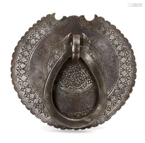 A Qajar engraved steel door knocker, Iran, 19th century, of circular form with crenellated edges,