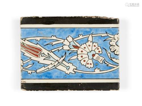 A Kutahya tile, Turkey, 18th century, of rectangular form, the cobalt-blue ground with design of