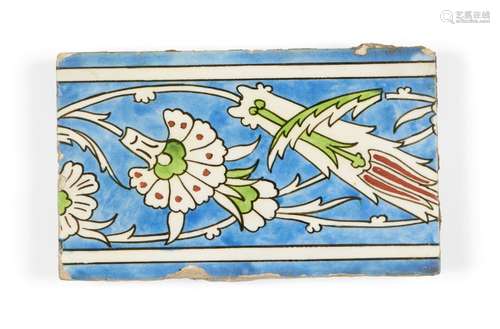 A Kutahya tile, Turkey, 18th century, of rectangular form, the cobalt-blue ground with design of