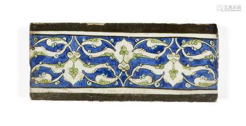 A Damascus Iznik border tile, 16th century, of rectangular form, the cobalt ground decorated in