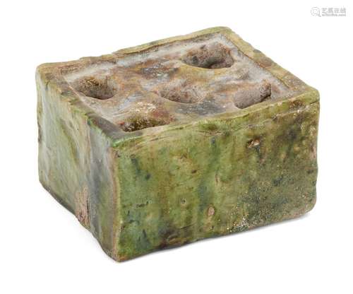 A glazed pottery inkwell, Central Asia 12th-13th century, of rectangular form with five circular