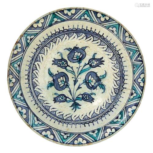 A large Iznik pottery dish with three large blue flowers, Ottoman Turkey, late 16th-early 17th