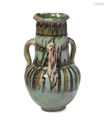 A Fatimid Fayyoum ware glazed pottery handled jar, Egypt, 11th century, rising from short foot