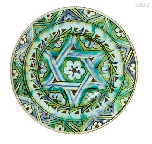 An Iznik pottery plate, Turkey, 17th century, with wide sloping rim and slightly raised well,