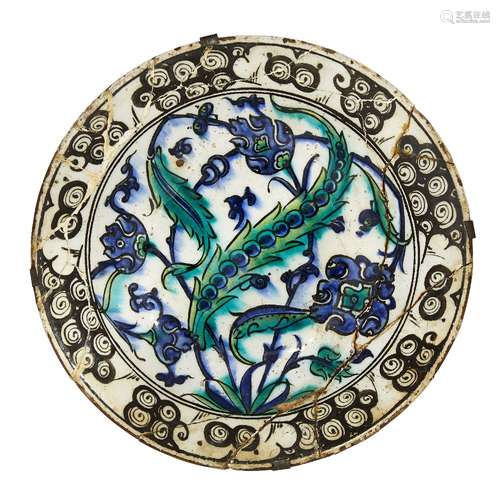 An Iznik pottery dish, Turkey, circa 1600, of deep form with sloping rim, underglaze painted in