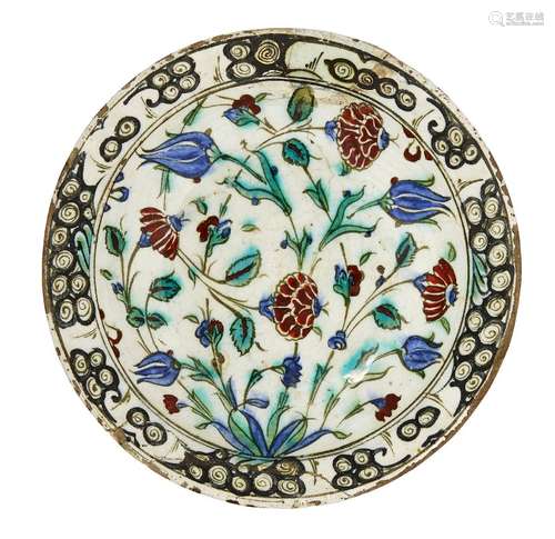 An Iznik pottery dish, Turkey, circa 1600, of shallow form, with sloping rim, underglaze painted